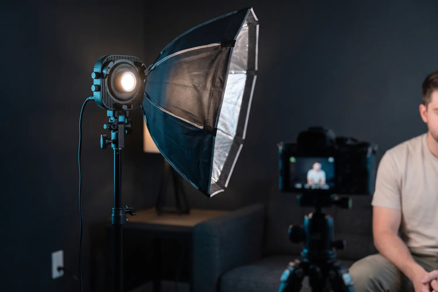 amaran Halo 100x with a softbox lighting a creator in a home studio