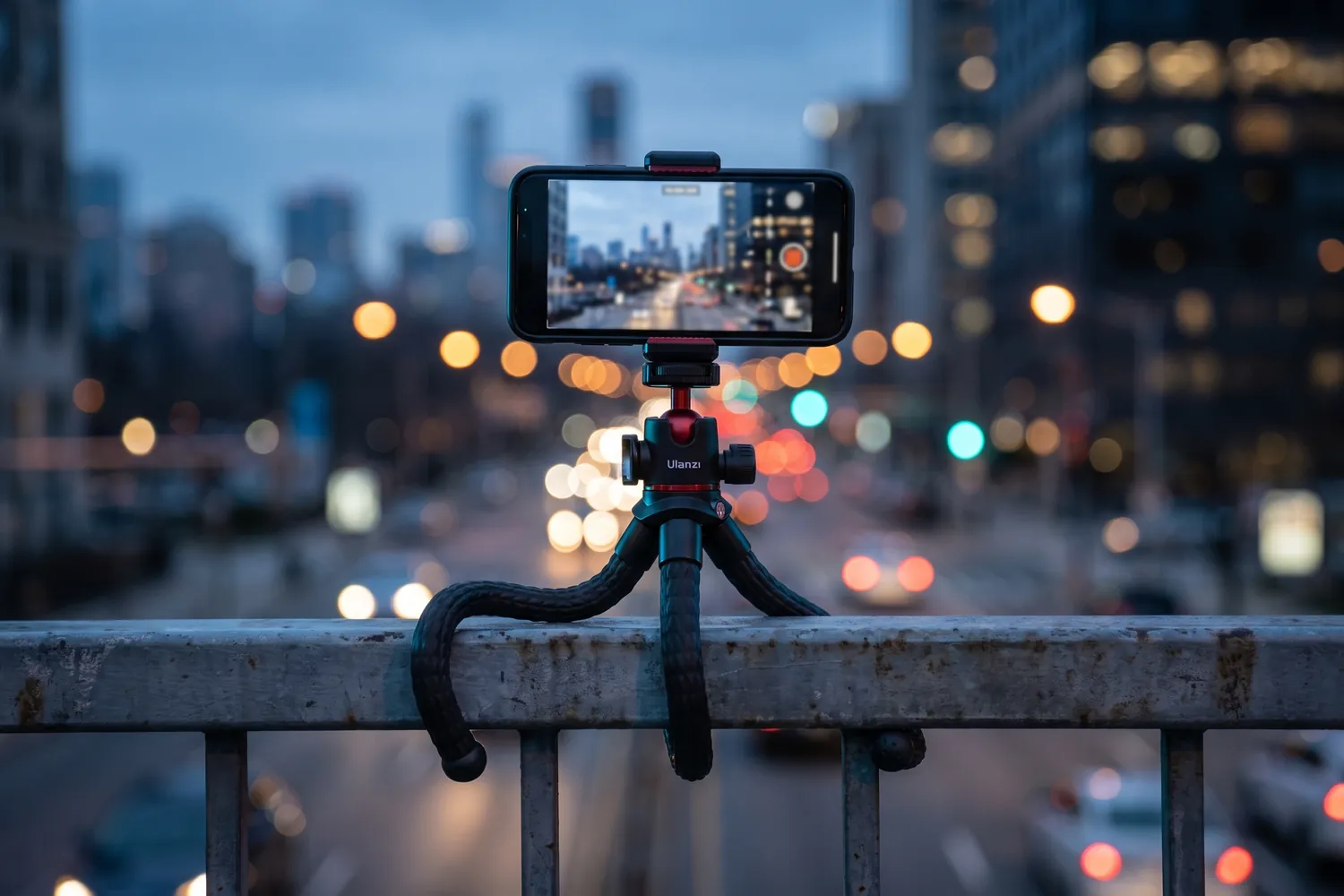 Ulanzi MT-33 wrapped around a railing, filming a city at dusk with a phone
