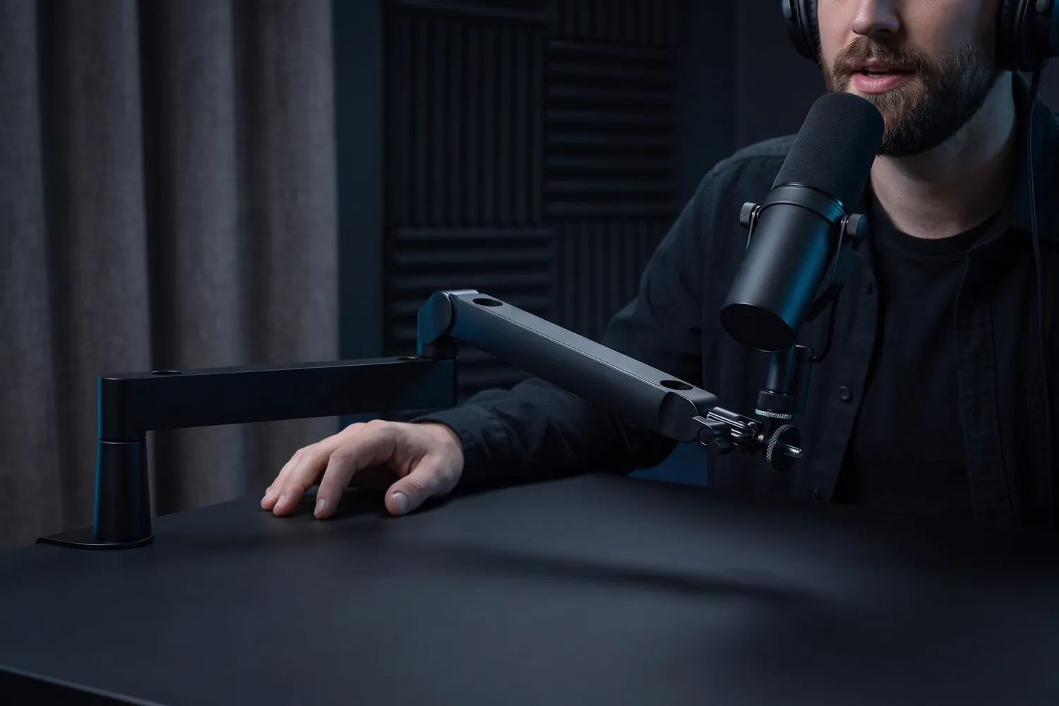 A podcaster speaking into a microphone on the Elgato Wave Mic Arm LP
