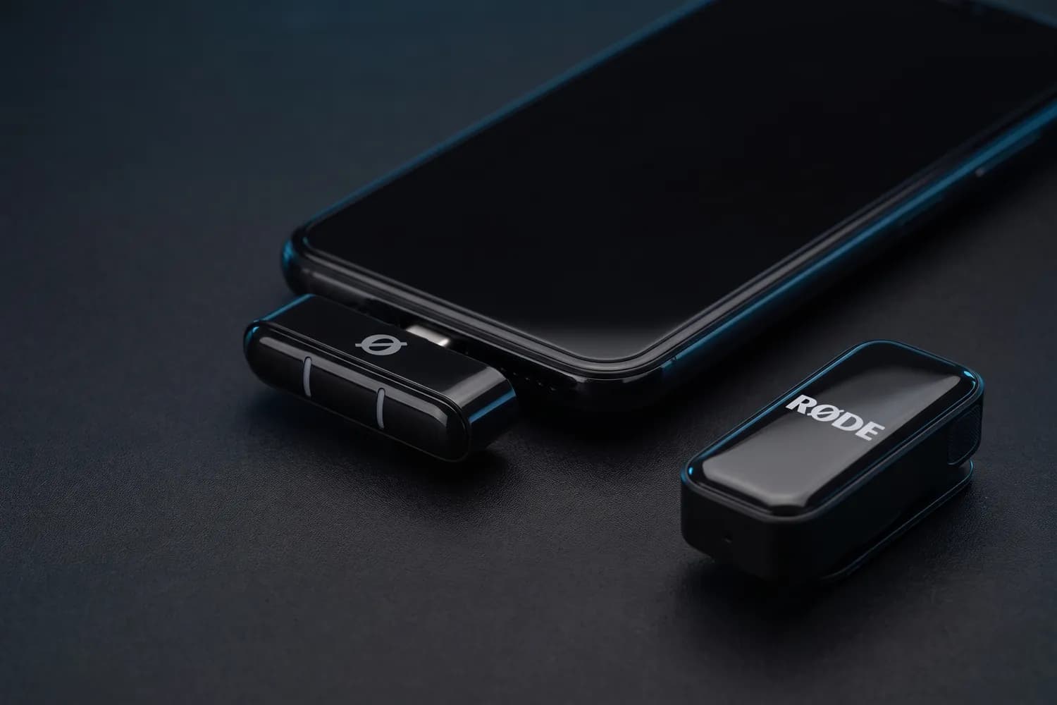 RØDE Wireless Micro receiver in a phone's USB-C port, a transmitter beside it