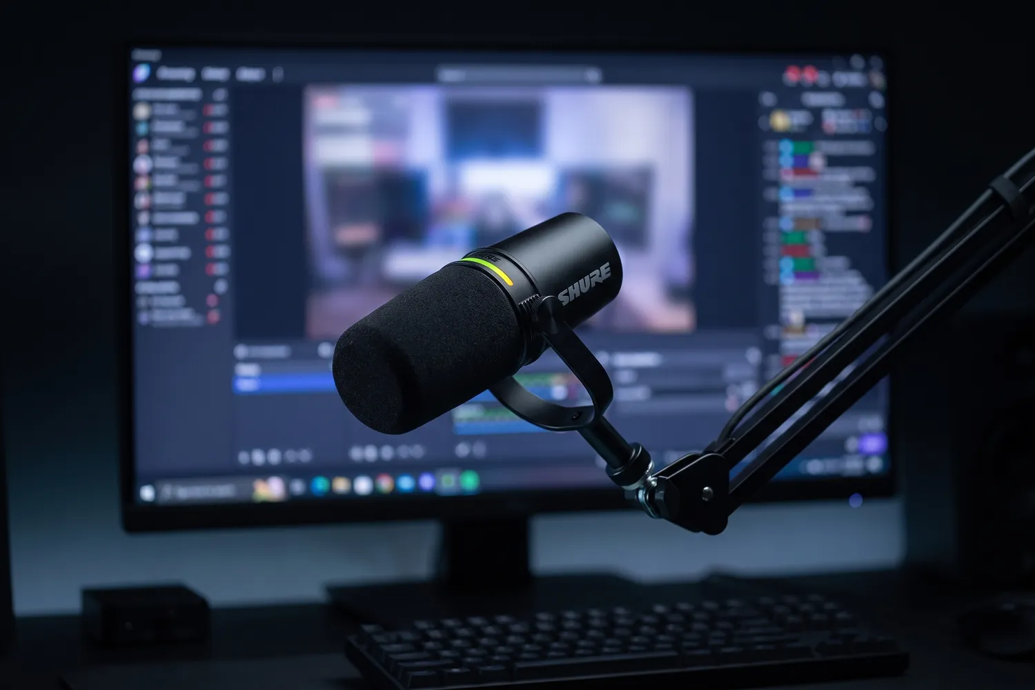 Shure MV7+ on a boom arm in front of a streaming monitor and keyboard