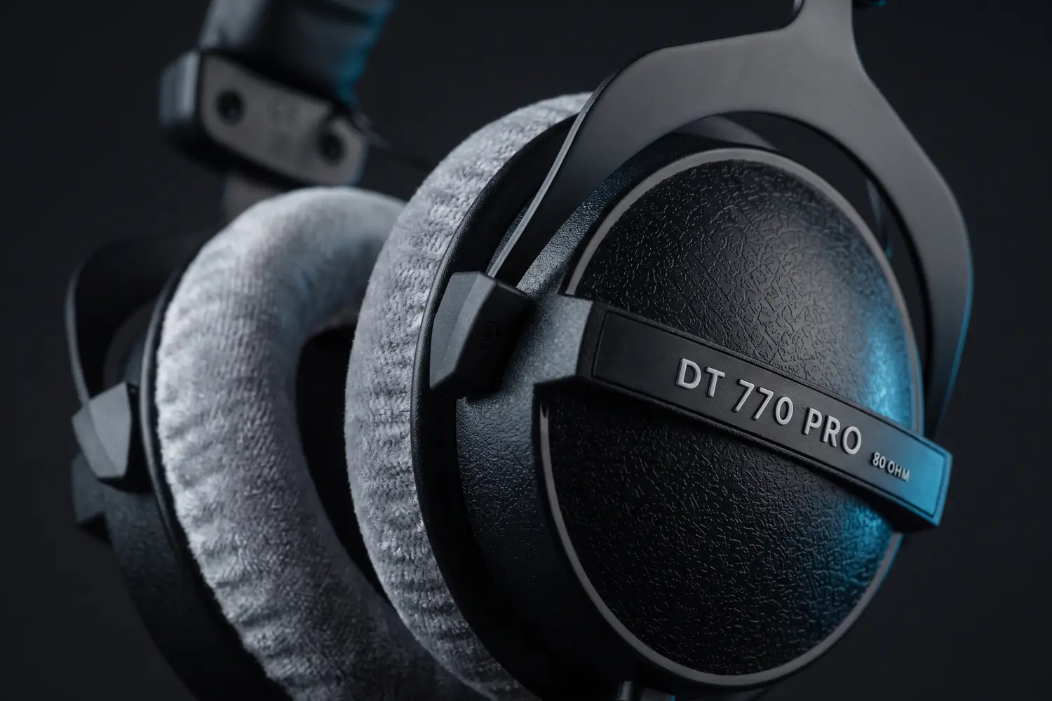 Close-up of a DT 770 PRO ear cup with its 80 OHM label and grey velour pad
