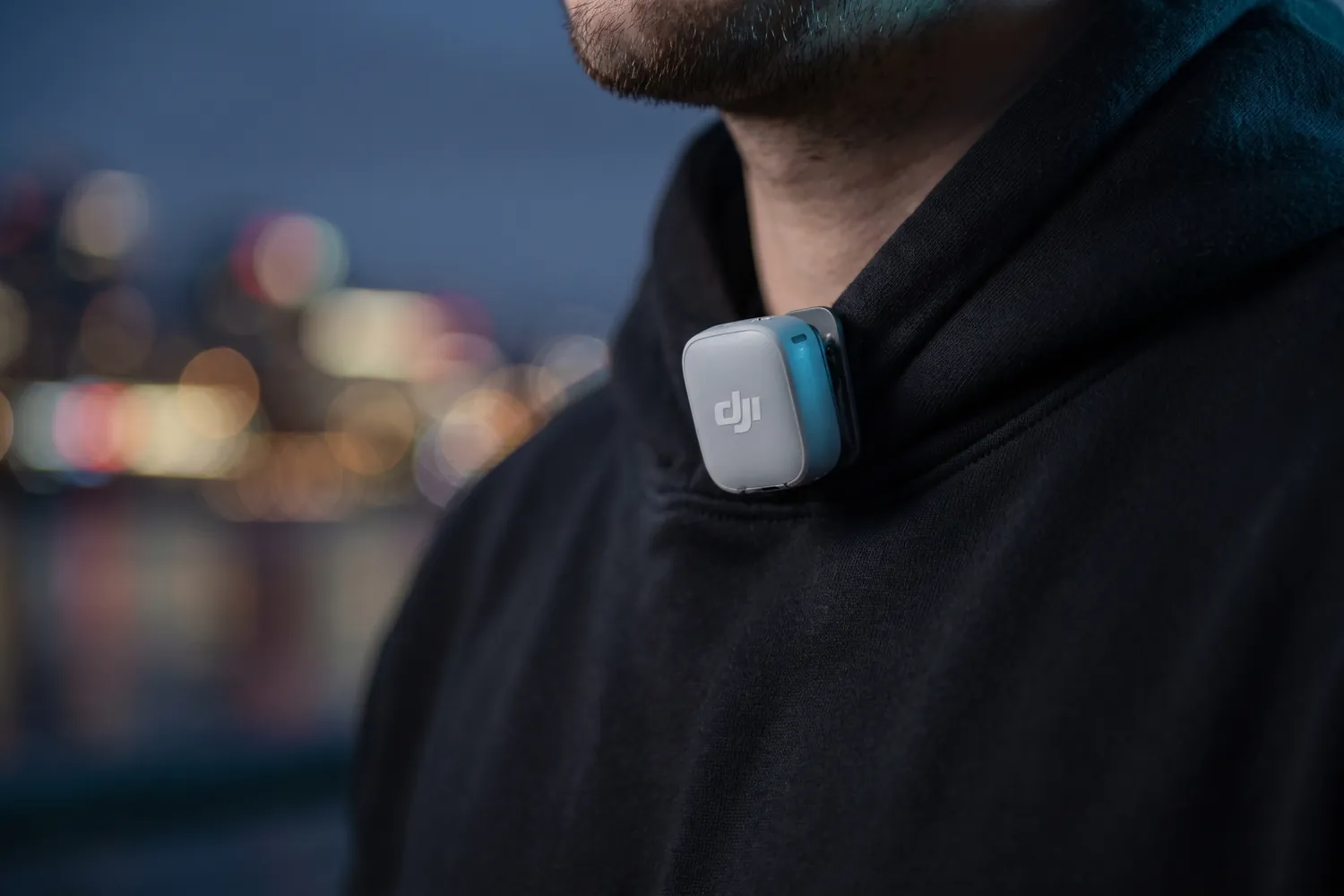 DJI Mic Mini 2 transmitter clipped to the collar of a black hoodie