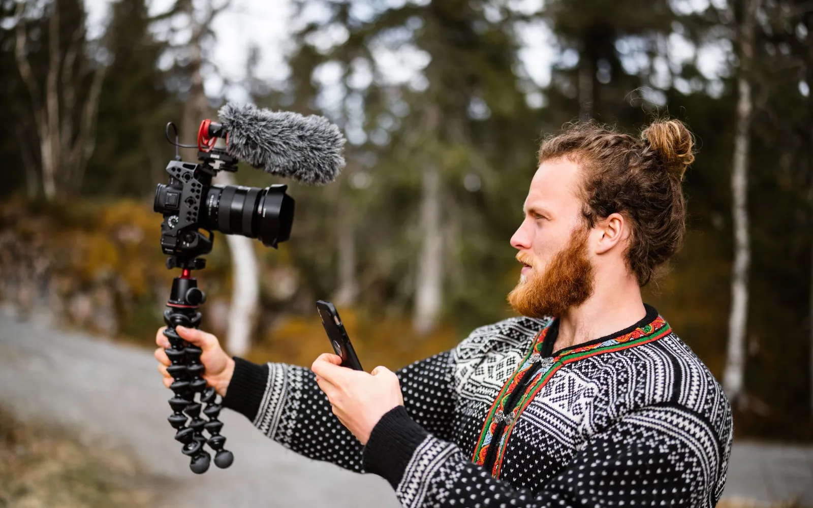 Sample footage: a man films himself in a forest with a camera and microphone.